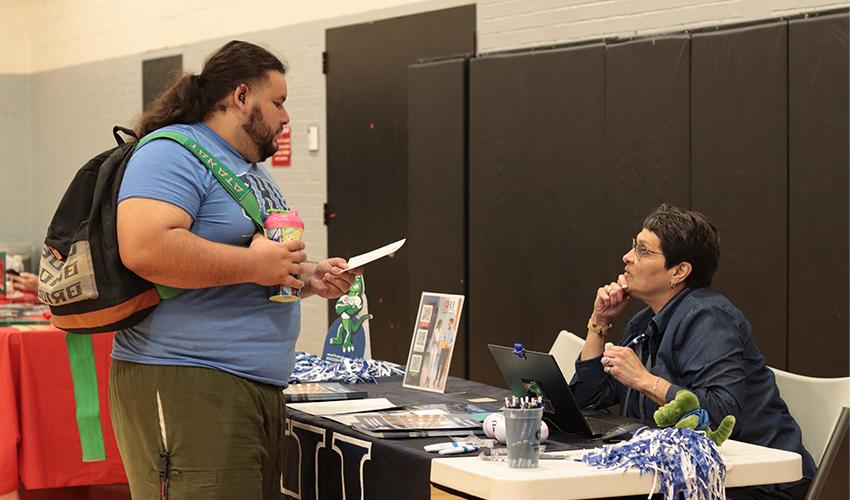 Student getting information at one of the Universities' booths.